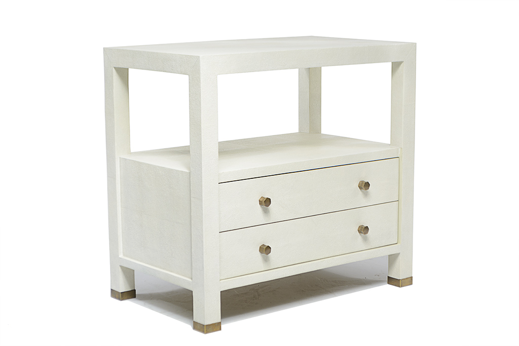 White nightstand with brass handles and a faux shagreen finish, presented in a side view.