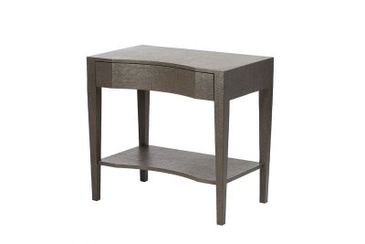 Fabre Seal Raffia nightstand with curved design and single drawer, displayed in a showroom or store.