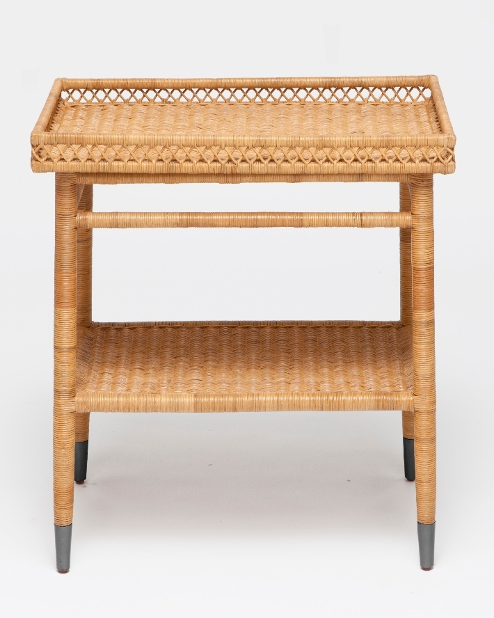 A large wicker side table with intricate natural rattan patterns, standing alone against a white background.