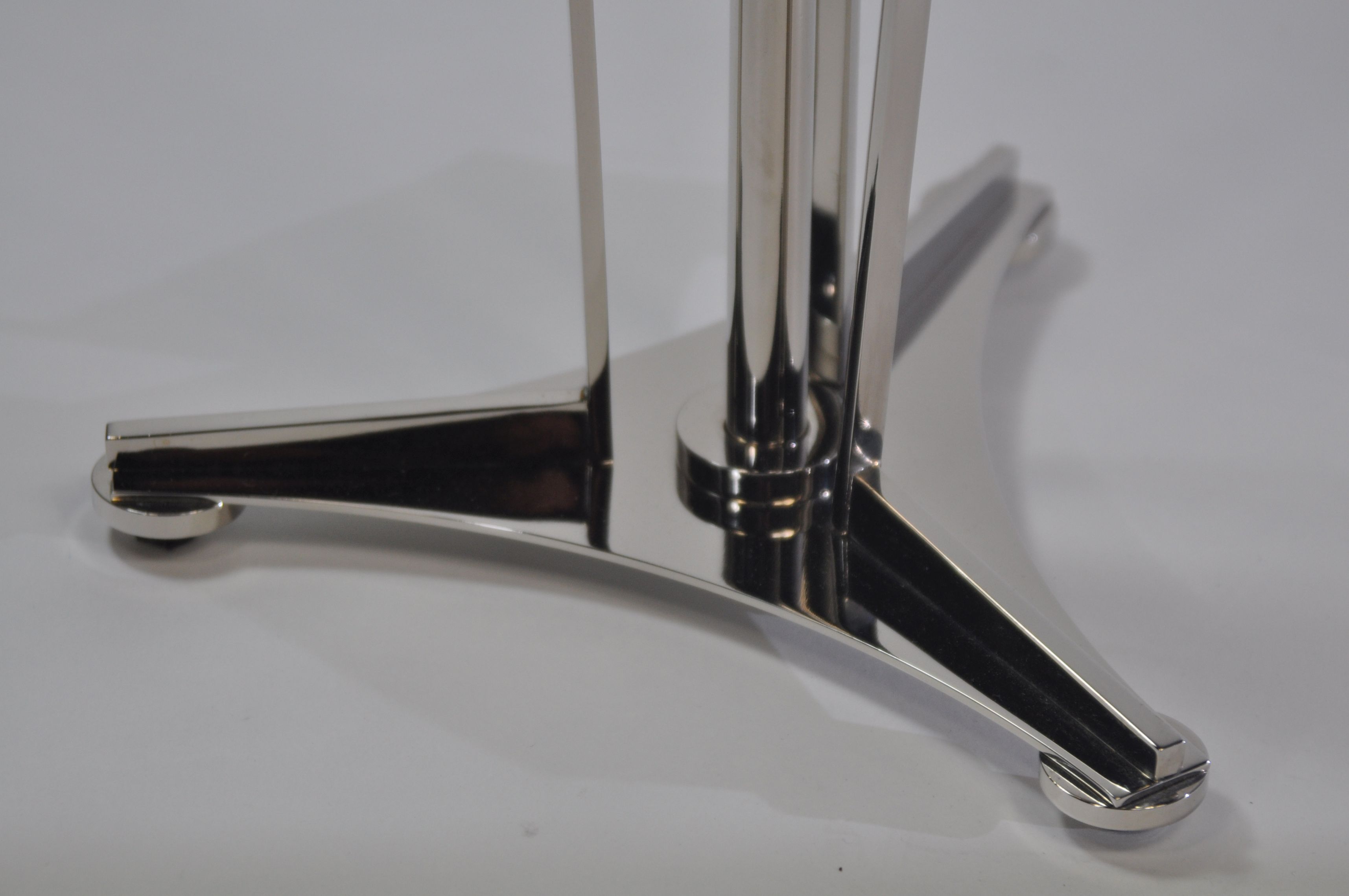 French modern side table with a nickel finish and mirrored top, positioned against a white background.