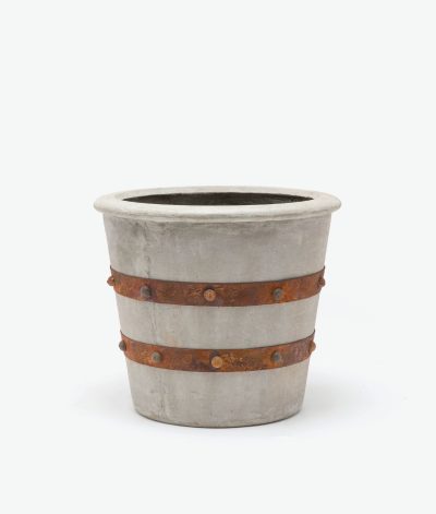 A concrete planter with rustic metal straps and large grommets, showcasing minor cracks and imperfections, presented in a close-up angle.
