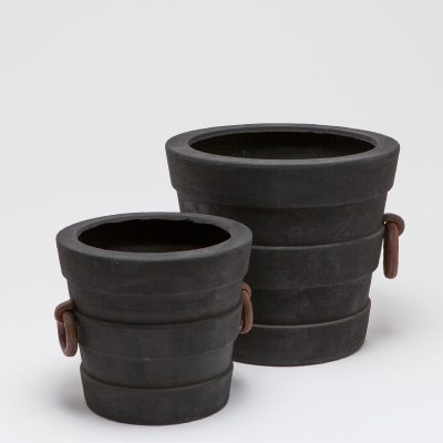 Two large black Elba oversized pots with rust handles, placed side by side against a white background.